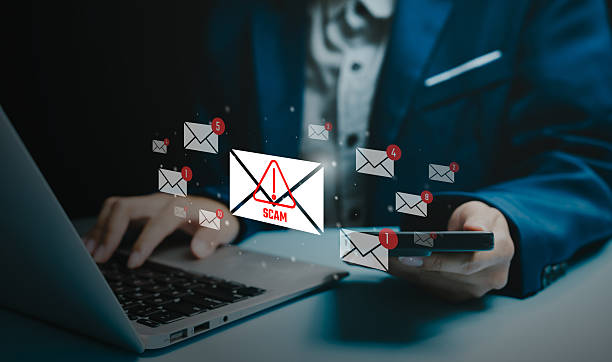 istock Cybersecurity threat concept, businessman using laptop and smartphone with scam email alert icons, phishing attack warning, online fraud risk, data protection, digital safety awareness. 2251704974