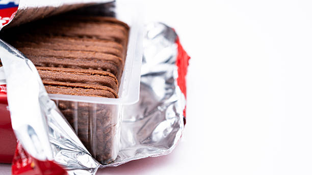 istock The image shows newly opened chocolate biscuits from their red foil packaging neatly arranged on a white background. 2251709606