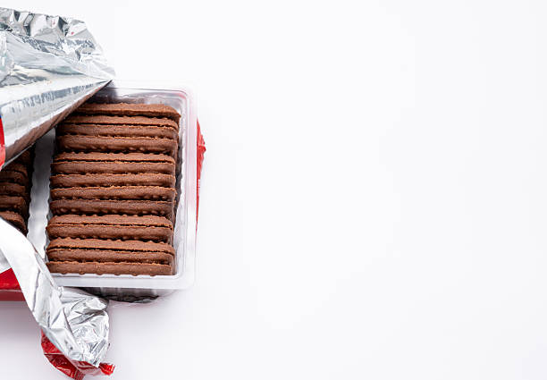 istock Row of Unwrapped Dark Cocoa Cookies in Plastic Tray 2251709628