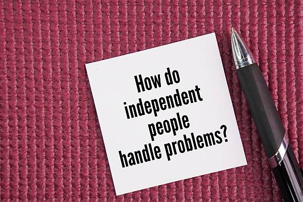 istock Pen and paper with question words How do independent people handle problems? 2251709954