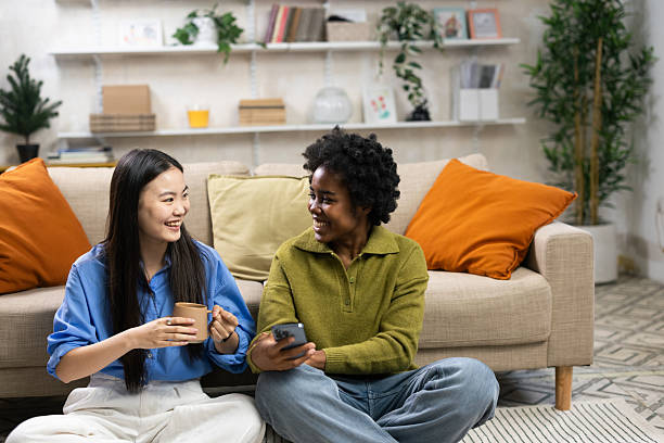 istock Diverse friends talking smiling relaxing at home 2251710833
