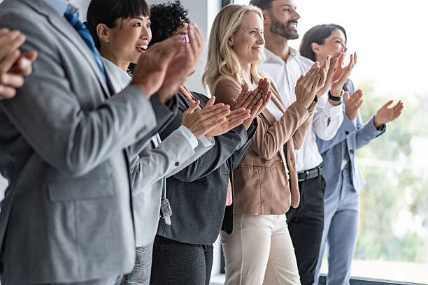 istock Encouraging Team Applauding in Bright Office Environment 2251712435