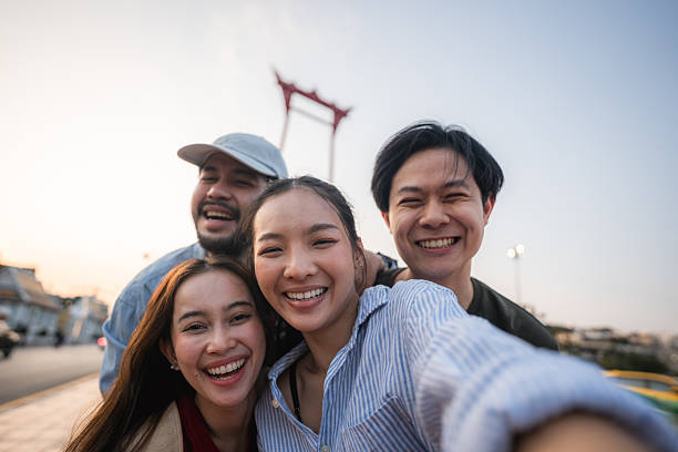istock Group of friends taking pictures and filming themselves with digital camera while exploring the city of Bangkok 2251713267