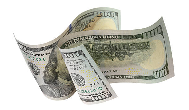 istock Two flying hundred dollar bills, isolated on white background 2251713613