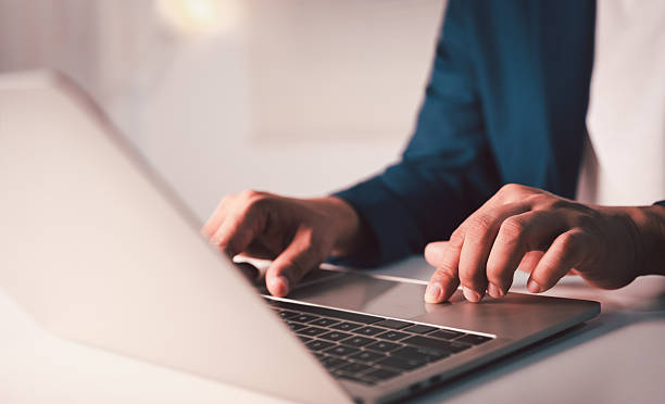istock Close-up A Man typing laptop computer communicates on internet technology on office desk. Workplace, Businessman professional working on new job project. Business technology concept. 2251715156
