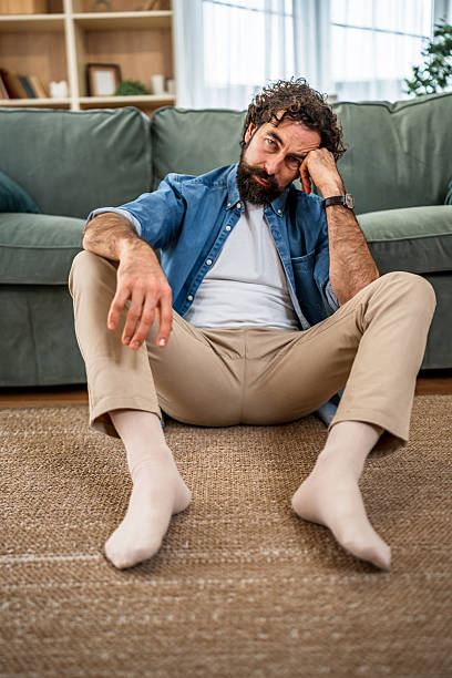 istock Man feeling sad and lonely at home 2251715715