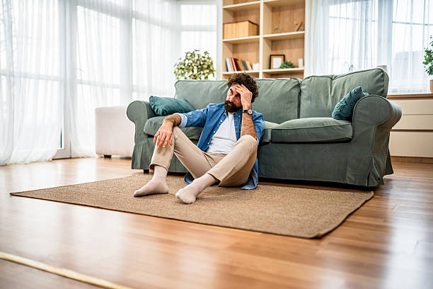 istock Man feeling sad and stressed at home 2251715741