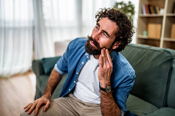 istock Man suffering from toothache experiencing dental pain at home 2251716221