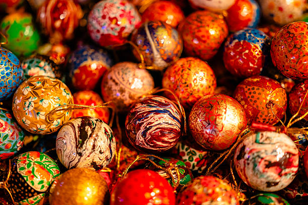 A vibrant collection of hand-painted Christmas ornaments featuring detailed patterns and rich colors.