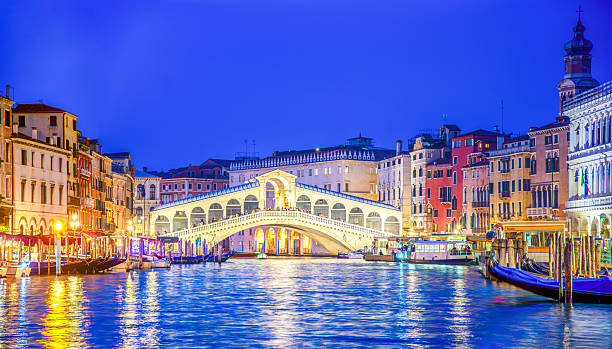 The Grand Canal and the Rialto Bridge at sunset in Venice, Italy