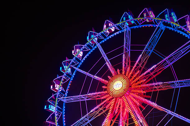 istock Illuminated Fairground Wheel Against Dark Sky 2251722804