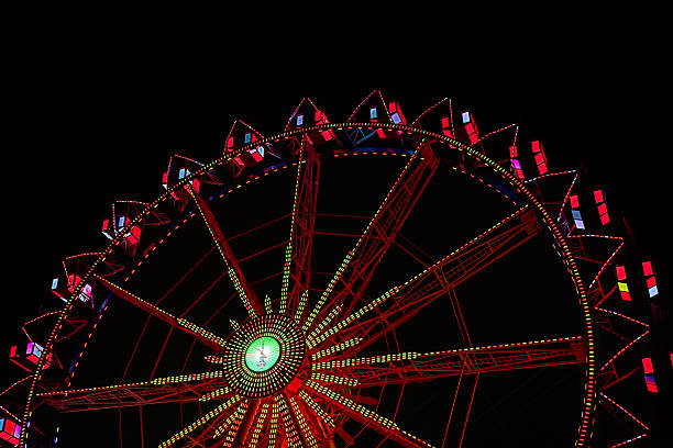 Illuminated ferris wheel at night during Berlin Christmas market.
