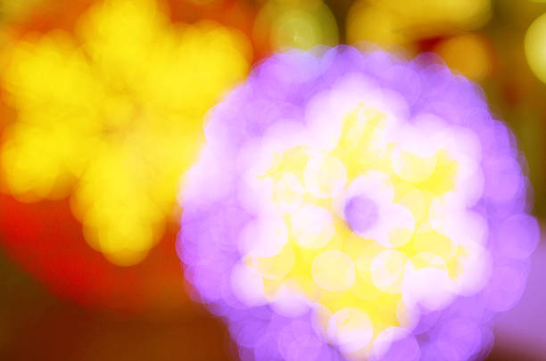 A beautiful purple Christmas ball is elegantly hanging down from a vibrant Christmas tree, adding festive color and charm to the decorations