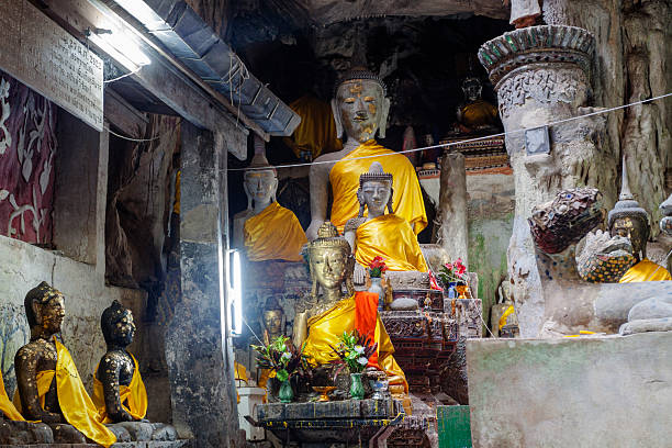 Illuminated  thai buddha statues in Chiang Dao Cave in Chiang Dao district north of Chiang Mai. Cave is large labyrinth of ways into rocks.
