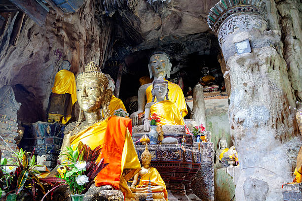 Golden and stony thai buddhas  in Chiang Dao Cave in Chiang Dao district north of Chiang Mai. Cave is large labyrinth of ways into rocks.