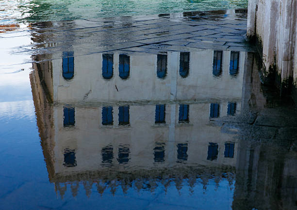istock Reflective architecture in water: historical building with blue windows 2251729365