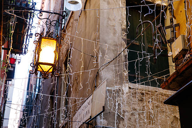 istock Vintage lanterns and string lights in quaint rustic alley 2251729488