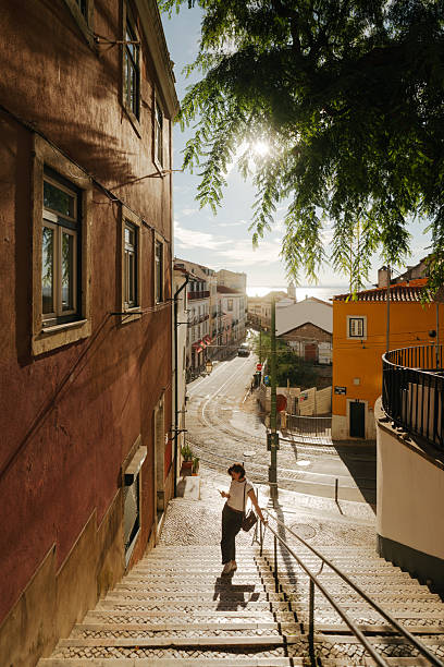 Photo of a woman using mobile phone, while on a city break vacation in Lisbon, Portugal