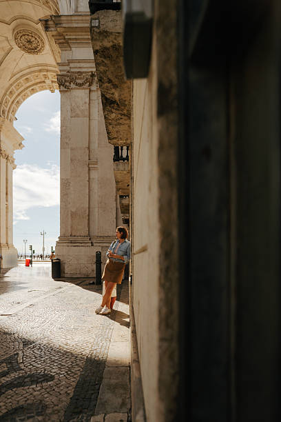 istock Female tourist using mobile phone while on a city break vacation 2251731037