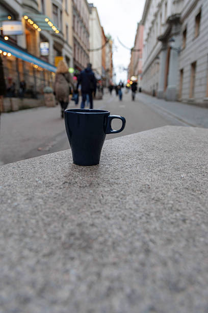 istock Dark Blue Ceramic Cup on Stone Ledge in City Street 2251734097