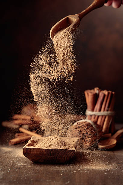 istock Cinnamon powder is poured into a wooden bowl. 2251737891