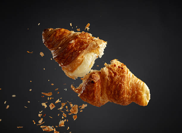 istock Croissant in air on a black background. 2251737909