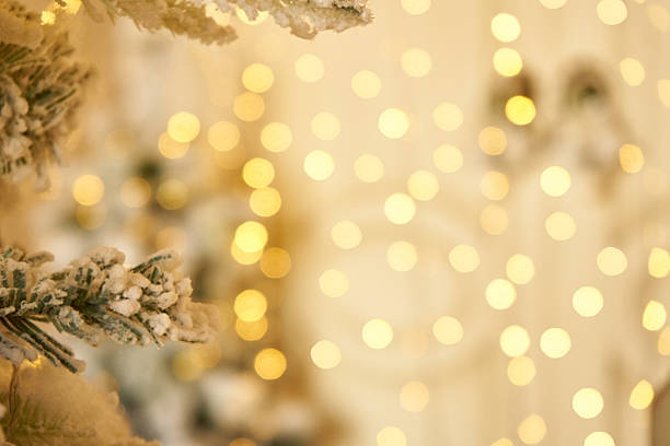 istock Blurred Christmas tree branch dusted snow and golden bokeh light background 2251739927