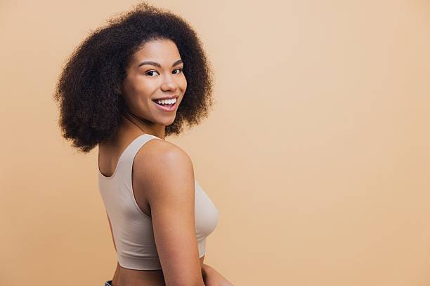 istock African American woman smiling looking back over shoulder 2251742843