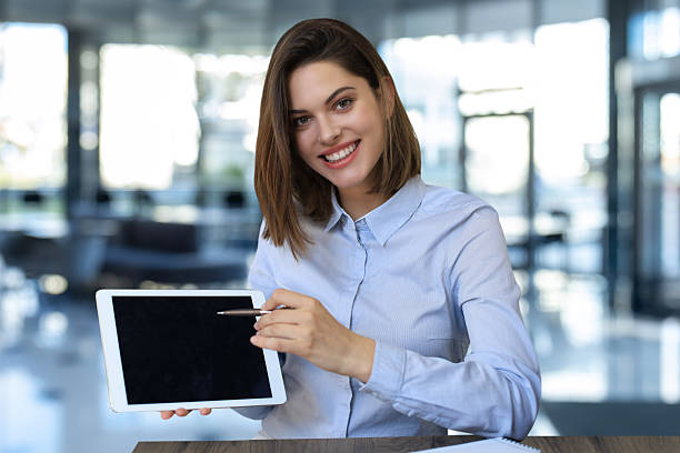 istock Young happy business woman showing blank tablet computer screen in office. 2251742865