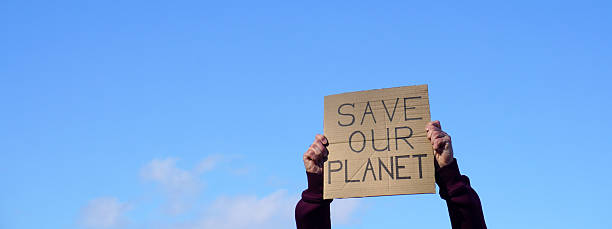 istock Activist holding save our planet sign protesting climate change 2251743049