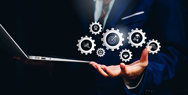 istock Digital workflow concept, businessman holding virtual gear icons system integration, business process automation, operational efficiency, smart technology, productivity optimization. 2251744055
