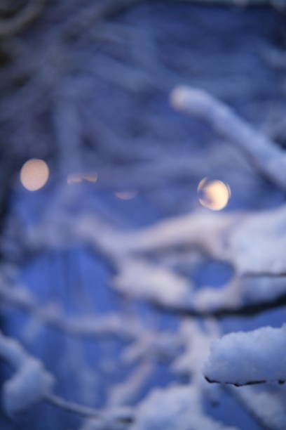 colorful sunrise sky outside the window, colorful play of light, shadows and reflections on the window glass, blurred outlines, winter