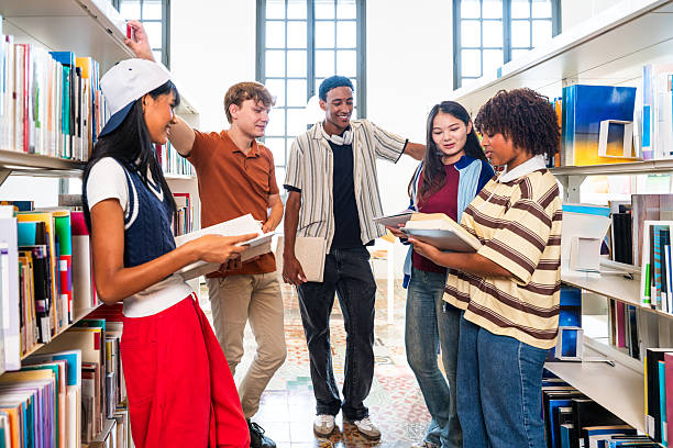 istock Multiethnic group of young students studying at library 2251746891