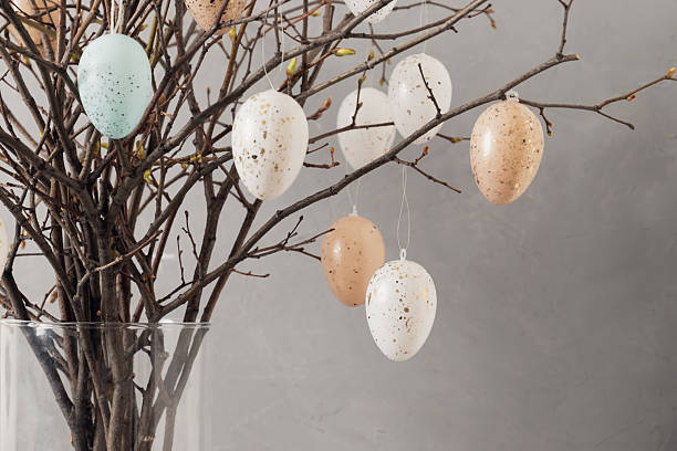 istock Easter tree with branches and eggs in glass vase. Spring decor at home interior. 2251746894