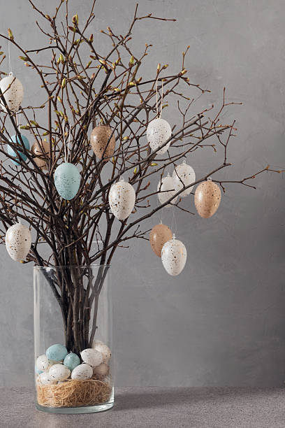 istock Easter tree with branches and eggs in glass vase. Spring decor at home interior. 2251746904