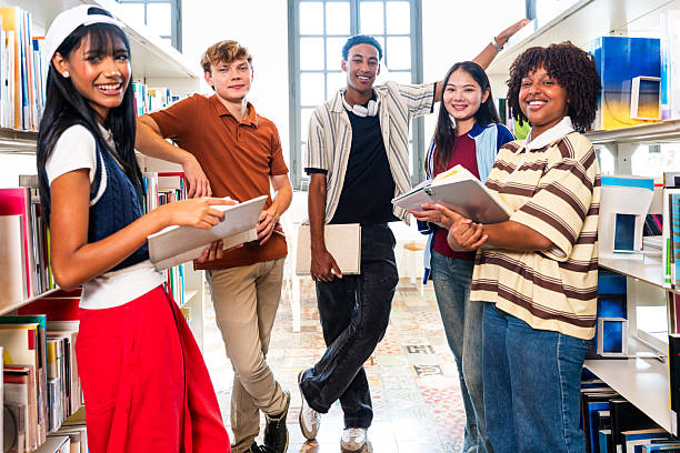 istock Multiethnic students studying together in library college 2251746937