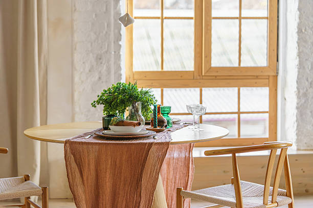 istock Cozy Scandinavian Christmas dining setting on table with natural decor on wide window background 2251748087