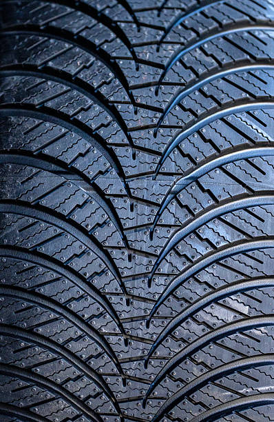 Close-up of new summer tire in a row, yellow background, copy space