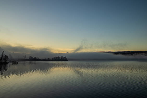 istock Misty Lake at Sunrise with Soft Reflections 2251753240