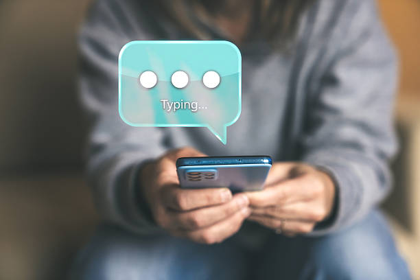 istock Anticipating a Response from the Other Person A Typing Notification Bubble Floats Above a Handheld Phone 2251759759