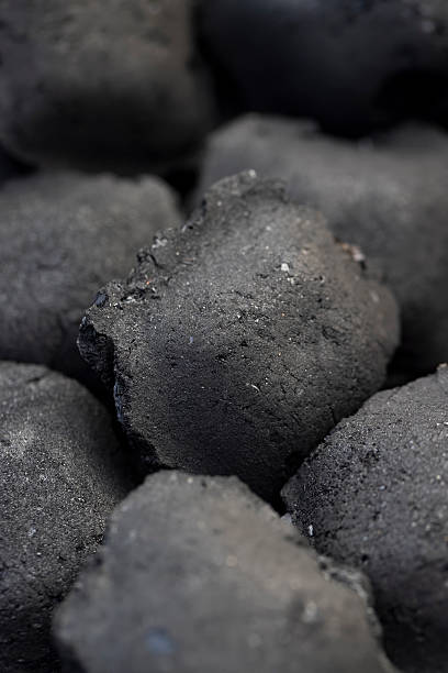 istock charcoal compressed from crumbs is obtained under pressure and used to light a fire and cook food on the grill, black charcoal in briquettes for grills 2251762477
