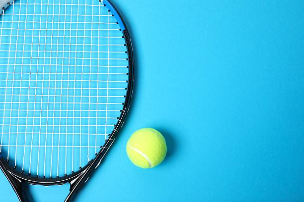 istock Tennis racket and ball on color background 2251762574