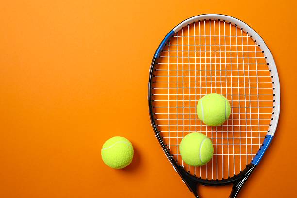 istock Tennis racket and balls on color background 2251762607
