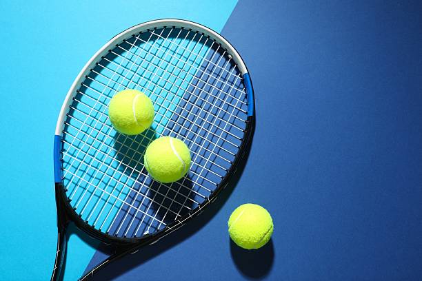 istock Tennis racket and balls on color background 2251762664