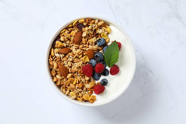 istock Delicious granola with berries and yogurt on a light background 2251765300