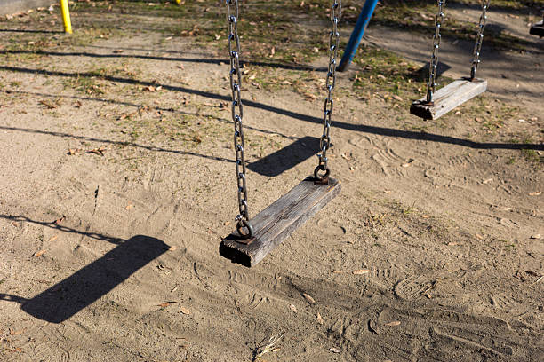 istock Nostalgic playground scene with a vintage wooden swing 2251767678