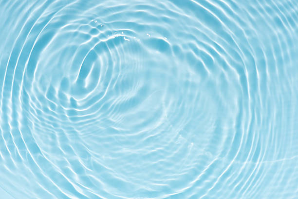 istock Blue water with ripples on the surface. Defocus blurred transparent blue colored clear calm water surface texture with splashes and bubbles. Water waves with shining pattern texture background. 2251768295