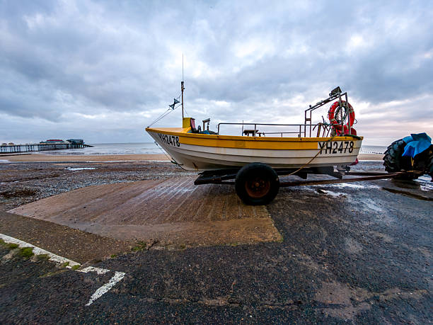 Cromer, Norfolk, UK - December 06 2025. Side on view of crab fishing boat on Cromer beach, North Norfolk Coast