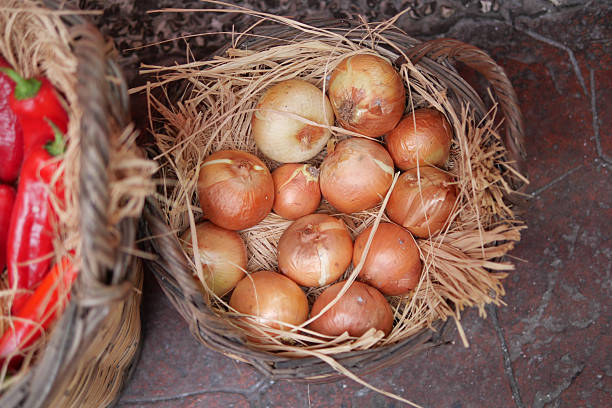 istock Fresh onions displayed in woven baskets at the market 2251770221