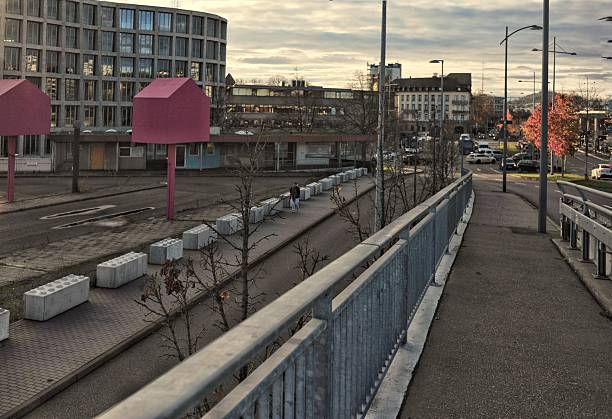 istock Quiet City Train Tracks Illuminated By Warm Sunset Light Overlooking Pedestrian Bridge And Distant Structures 2251773227